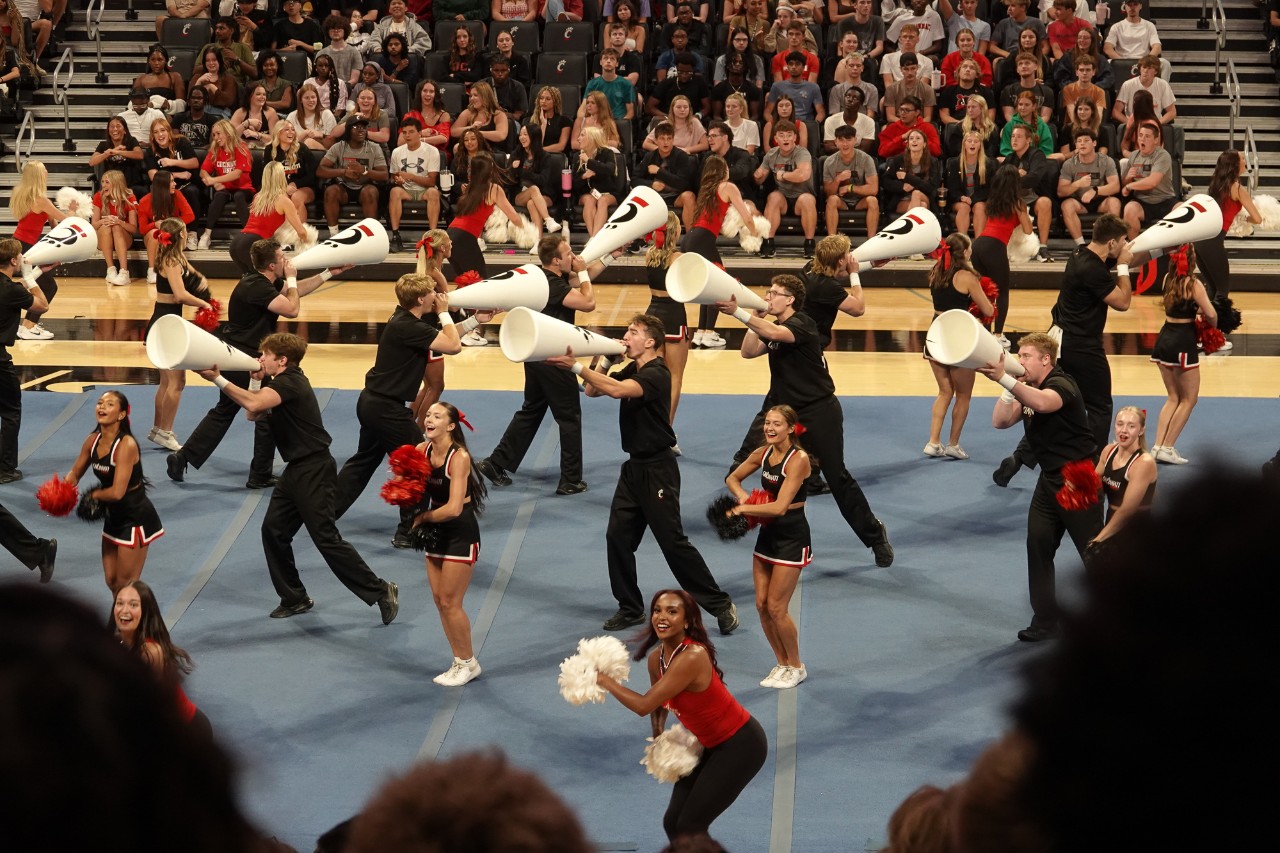 UC's Cheerleading Team performs on the floor of Fifth Third Arena.