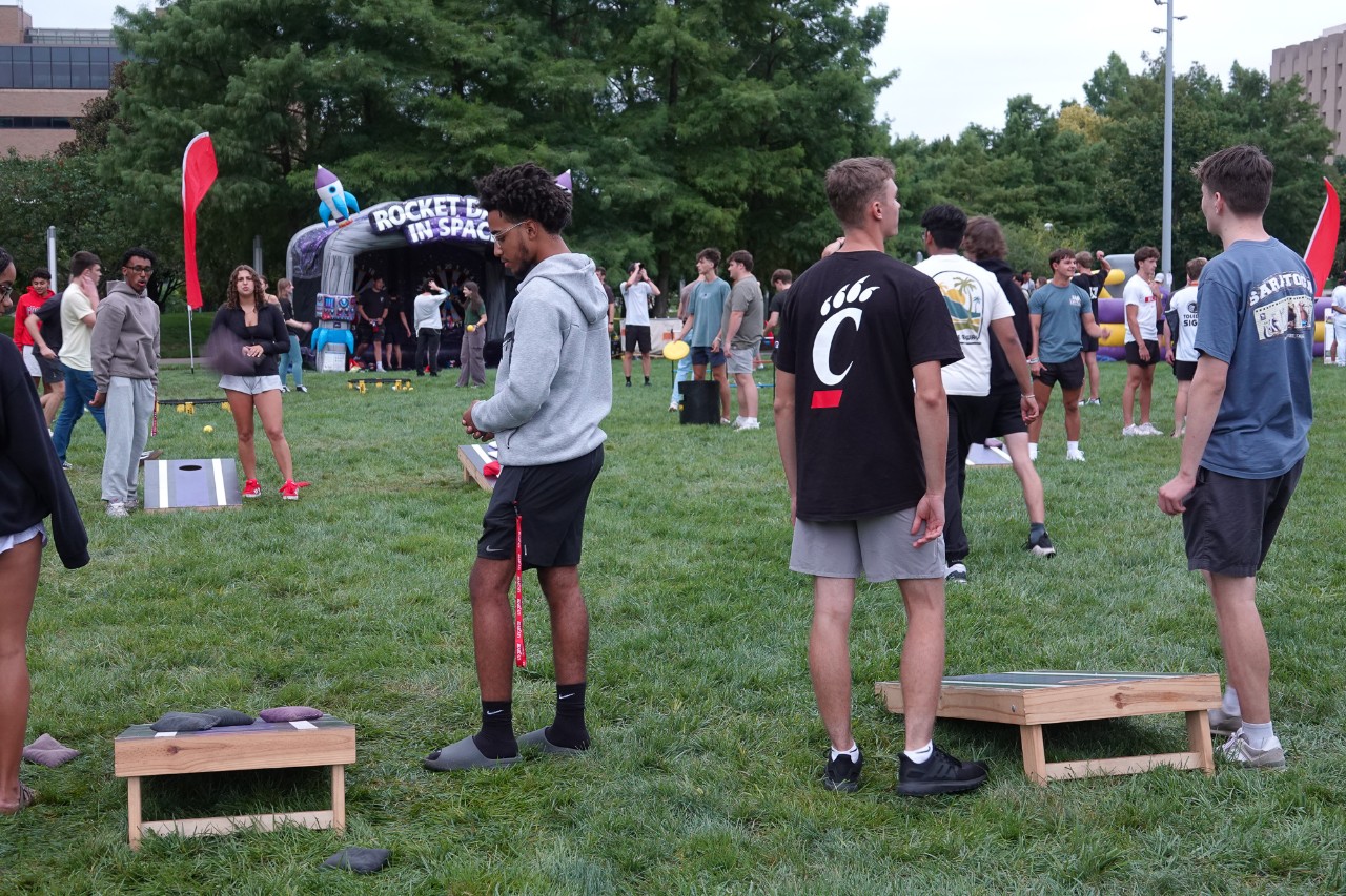 UC students play cornhole on campus. 