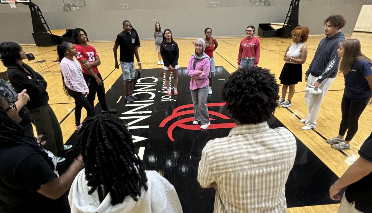 Students standing in circle around one student in the middle