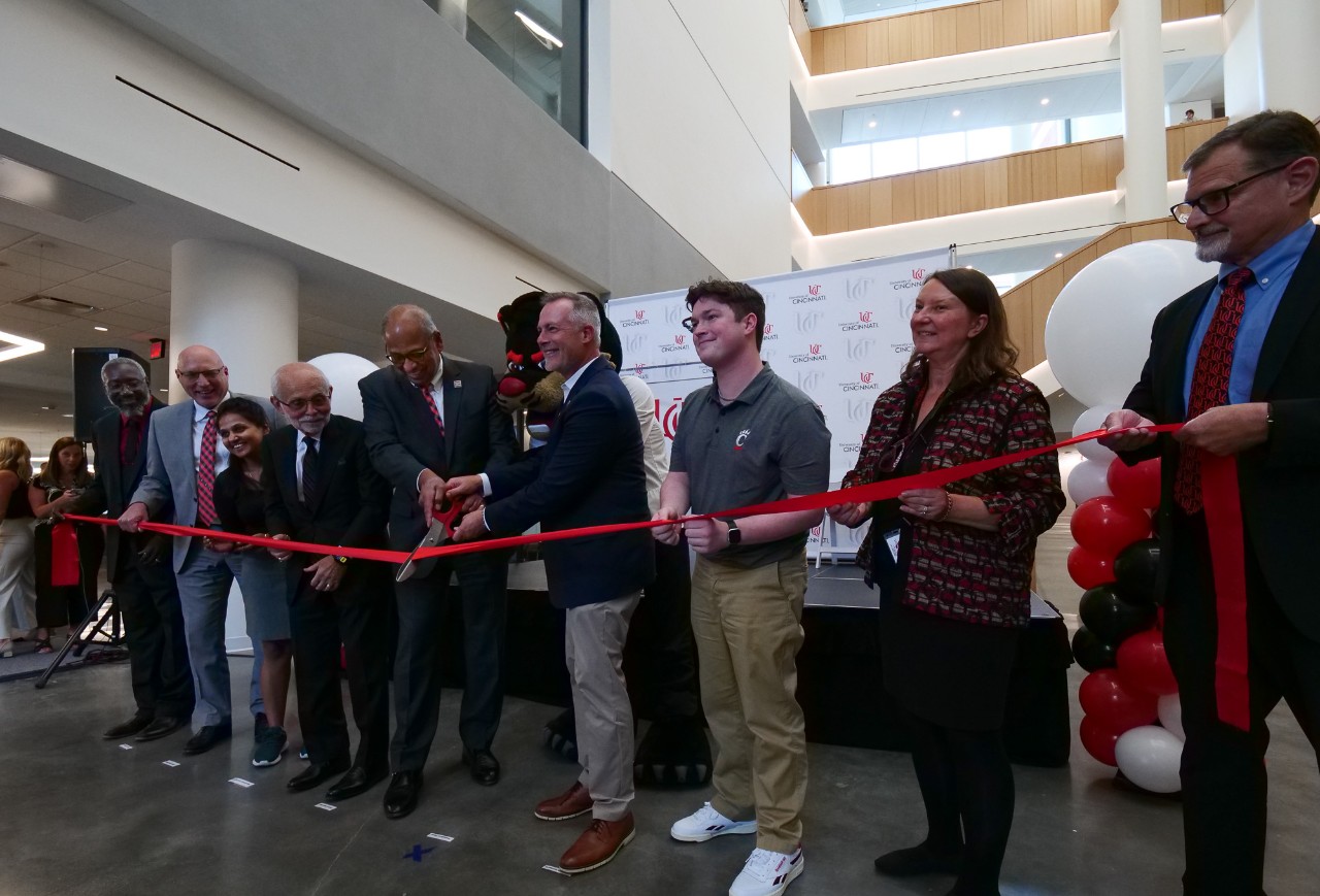 Dignitaries cut the ribbon in the atrium of Old Chem.