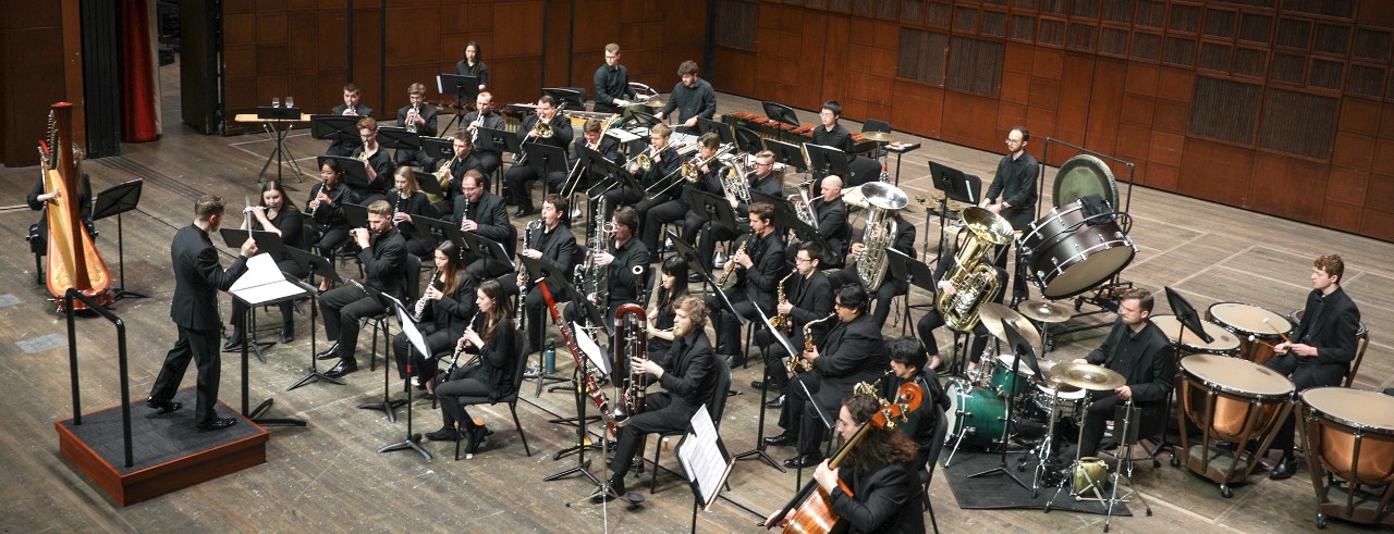 CCM Wind Symphony performs on stage.