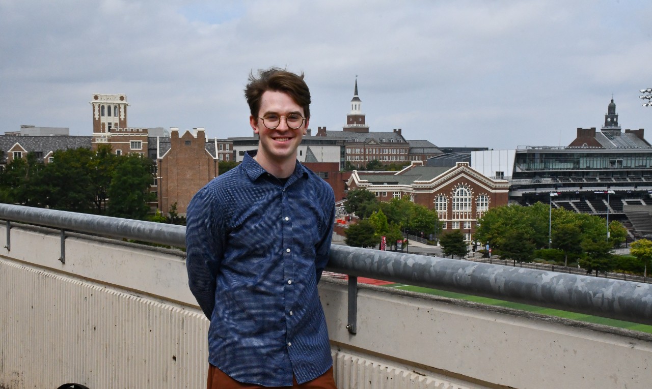 Samuel Hall poses in front of an overlook of UC's Uptown Campus.