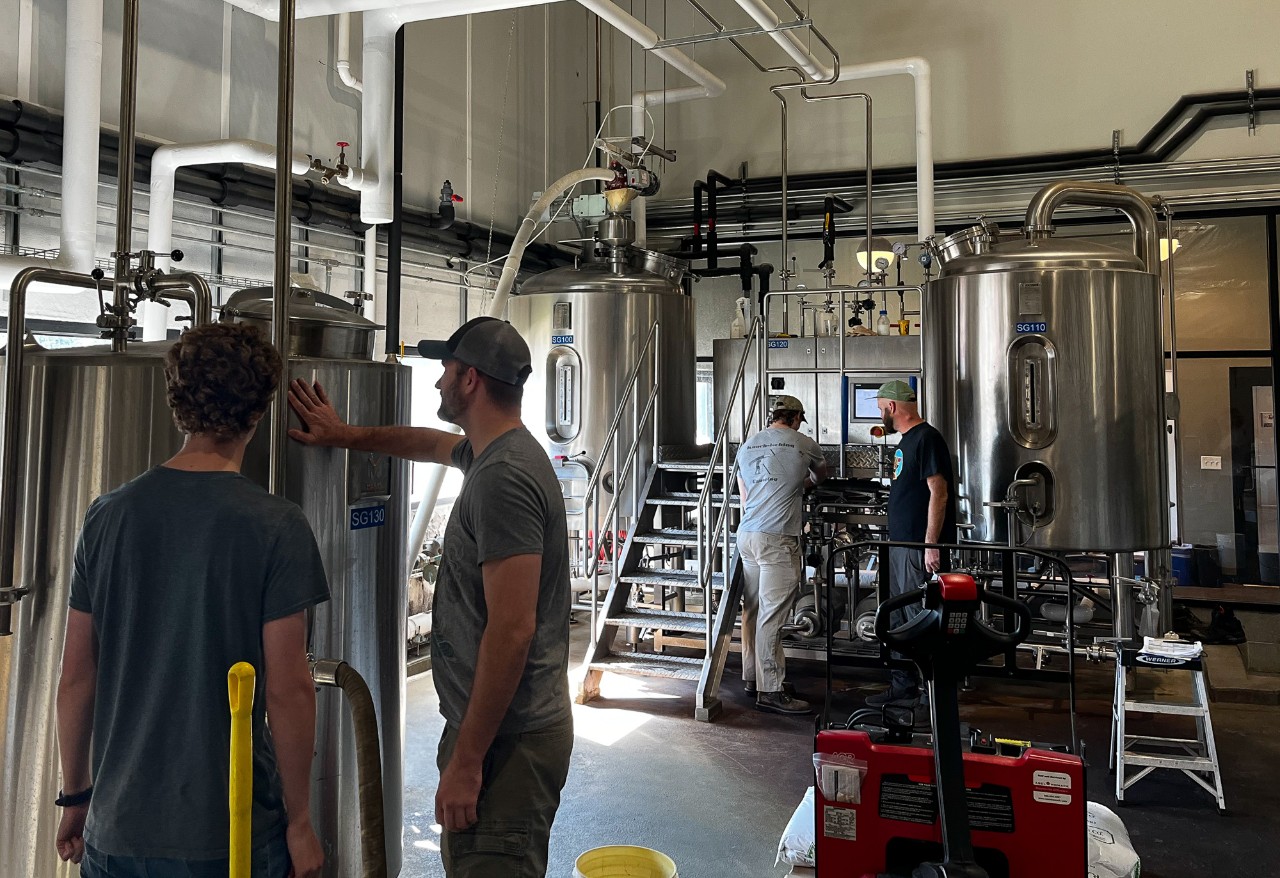 Students examine a brewery.