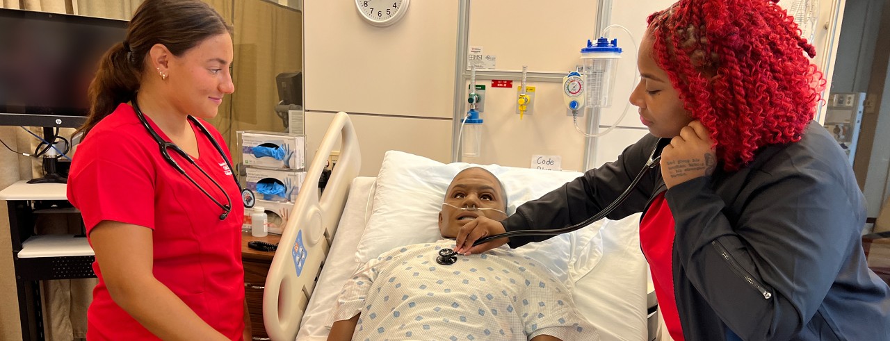 two students checking on mannequin 