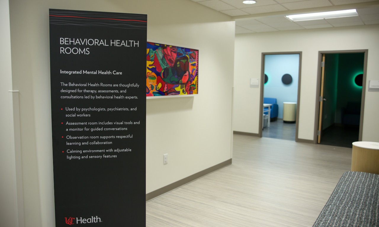 Hallway sign in a medical clinic stating Behavioral Health Rooms, Integrated Mental Health Care.