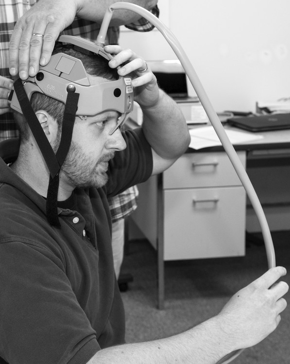 Drs. George Shaw, Matthew Flaherty and Ope Adeoye with Dan Kincaid and Joe Korfig.  Group photo with brain device.