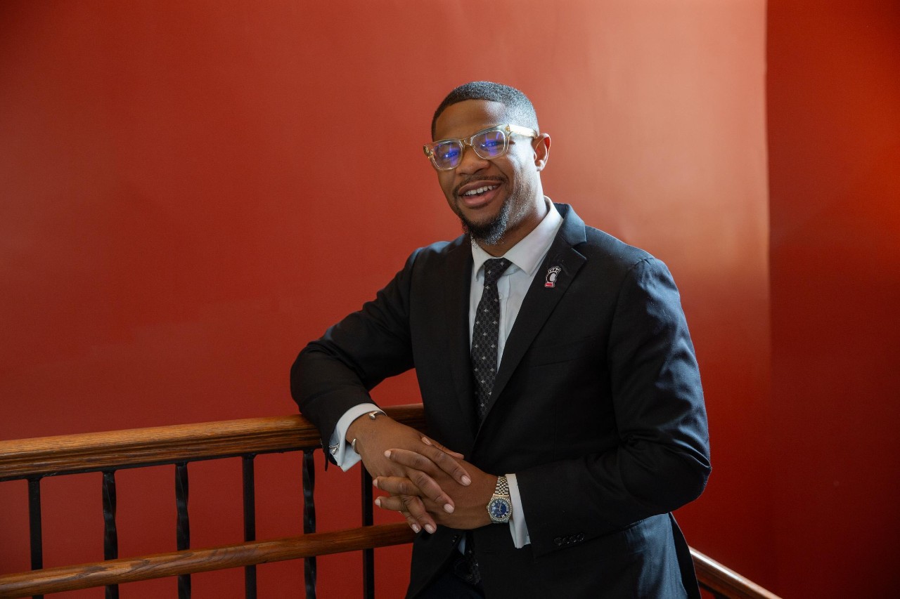 UC student poses for photo in his career fair outfit