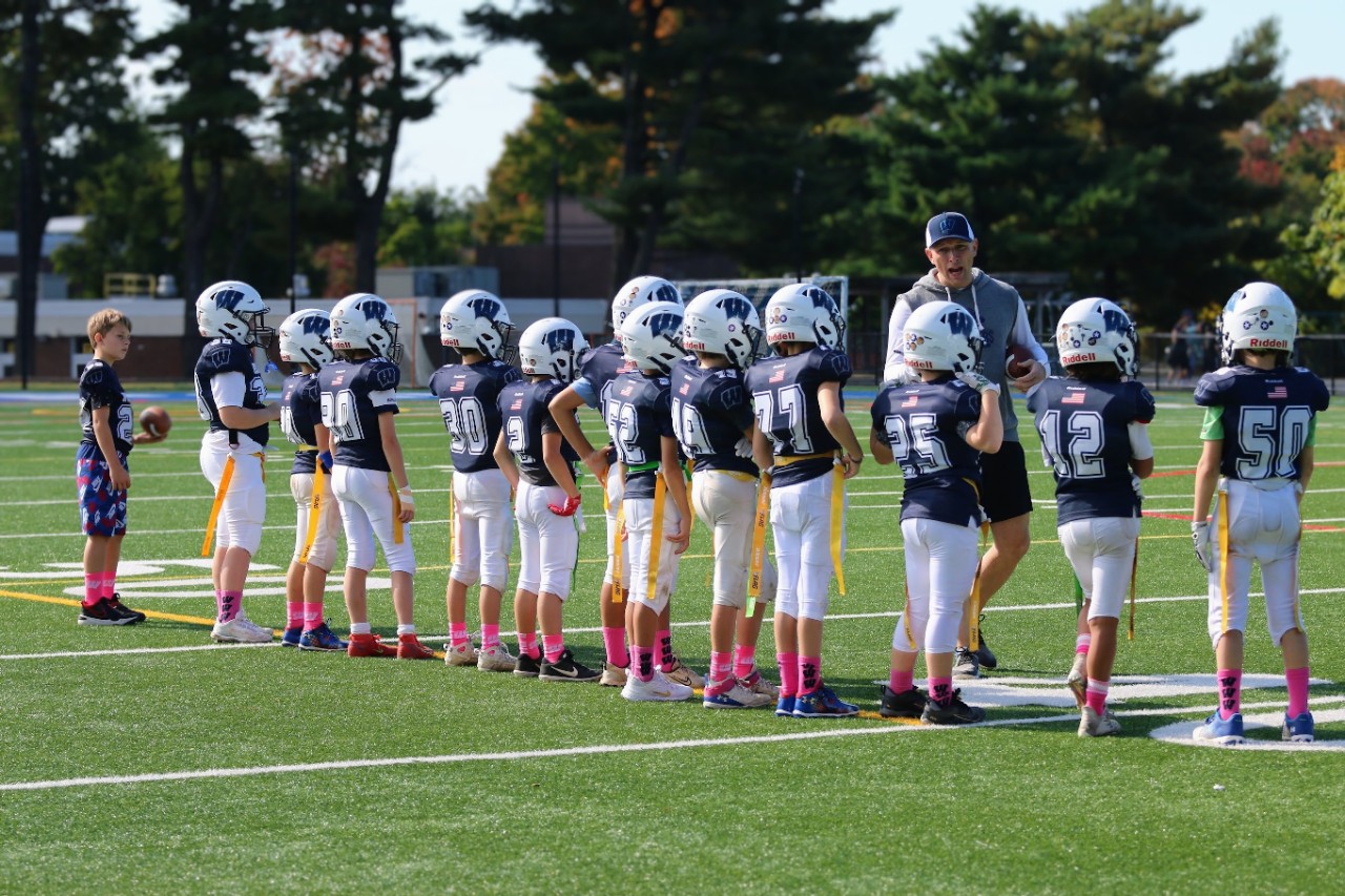 Flag football team lines up for high fives. Photo/Win Win