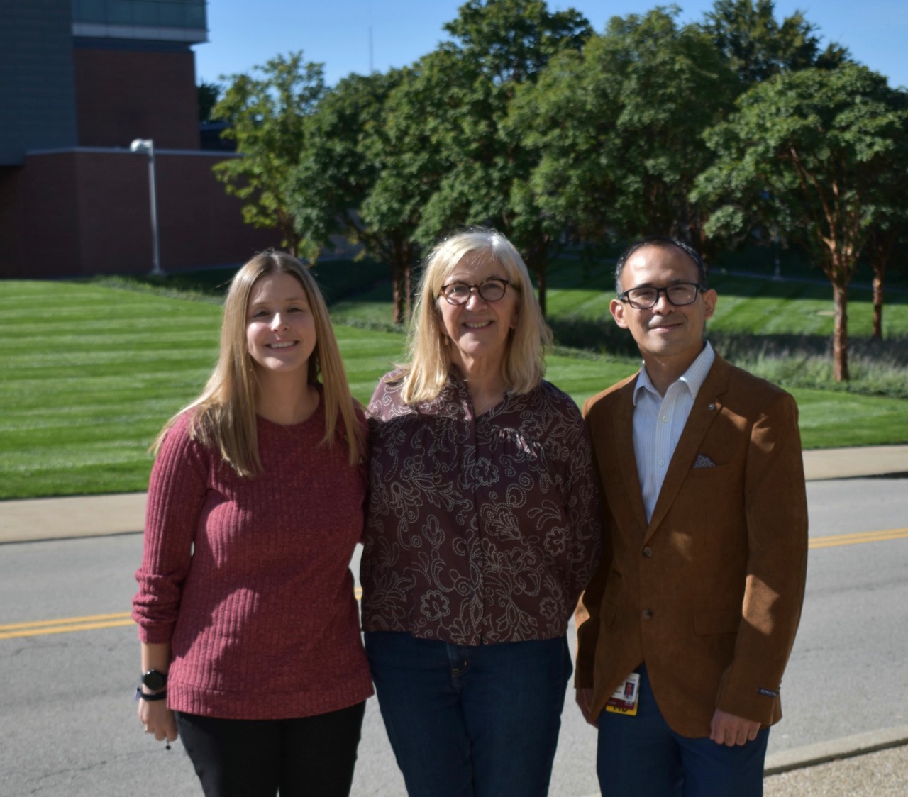 Three people who lead CCTST K Scholars Program standing outside 