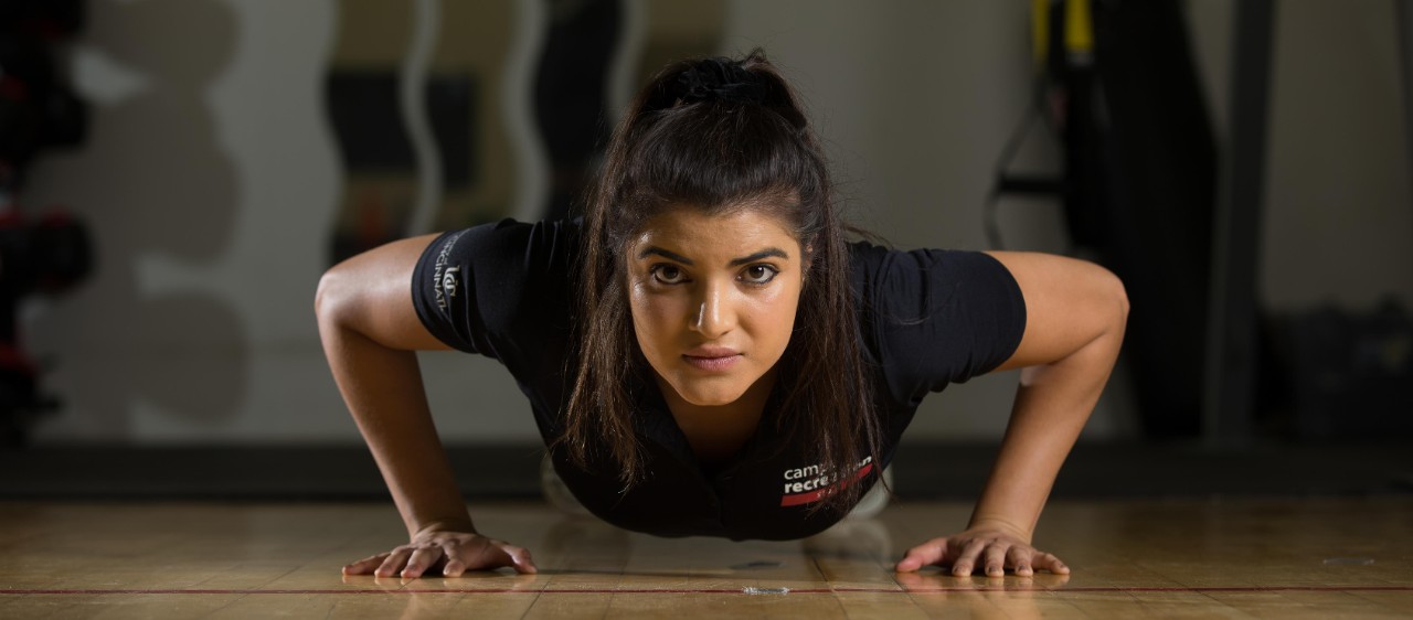 A UC student does a pushup.