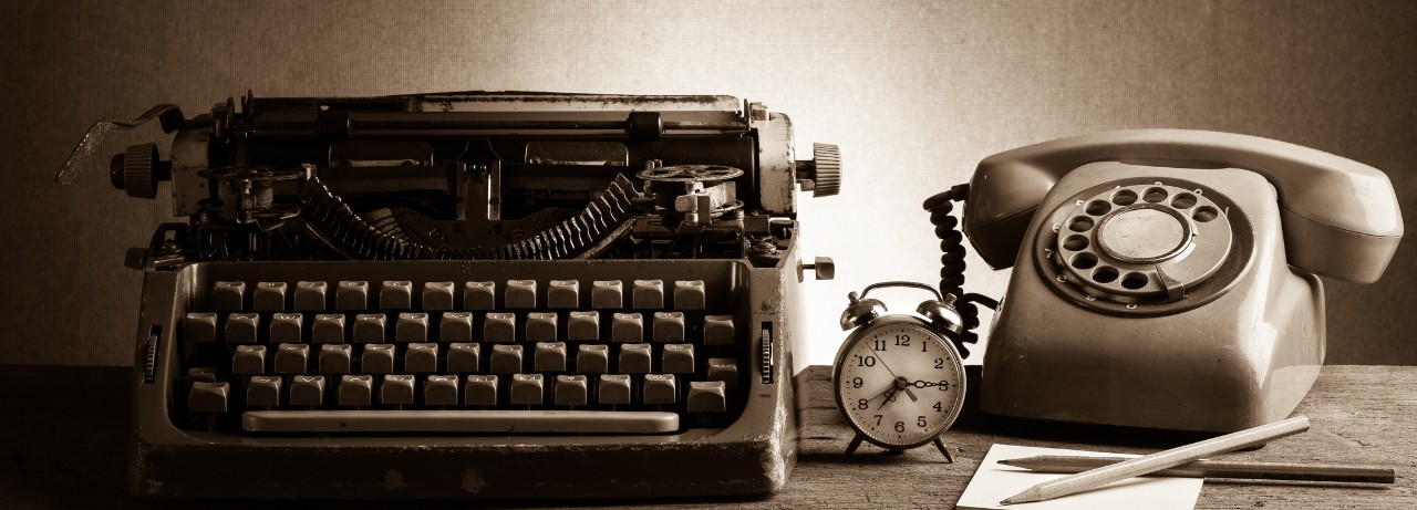 old fashioned typewriter and telephone