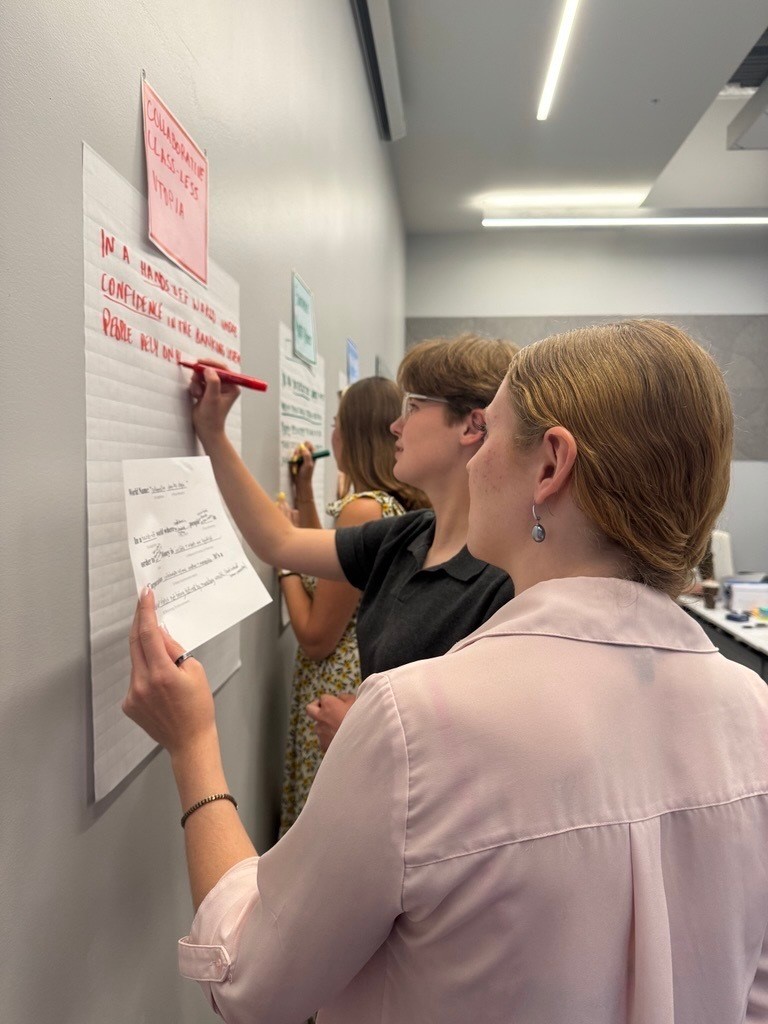 Students at a whiteboard working on solutions. 