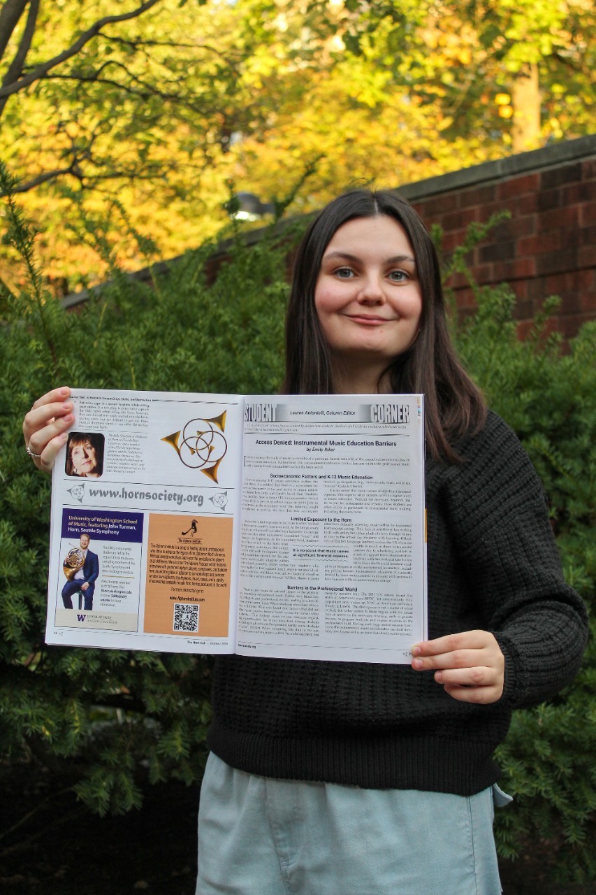 Emily Riker poses with her published article.