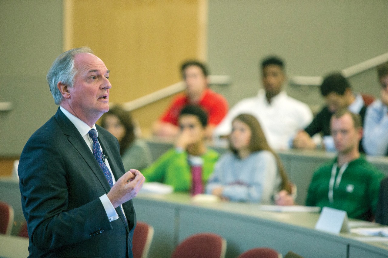 Paul Polman wears a suit and a tie whilst instructing students at the old Lindner Hall.