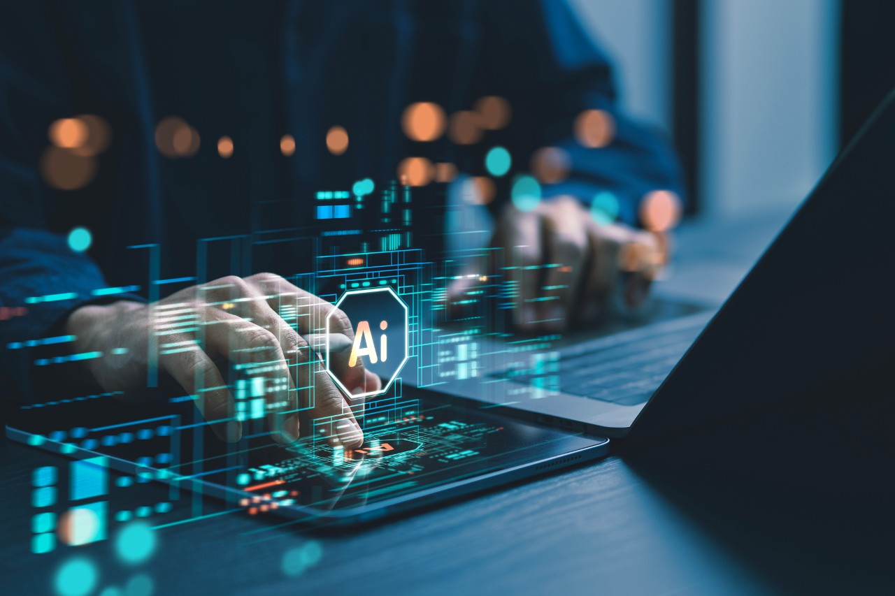 AI-themed overlay on person using a laptop and tablet.