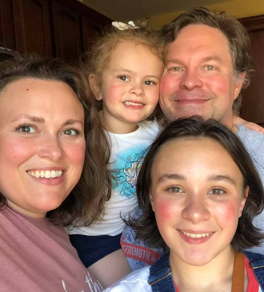 Four people smiling.