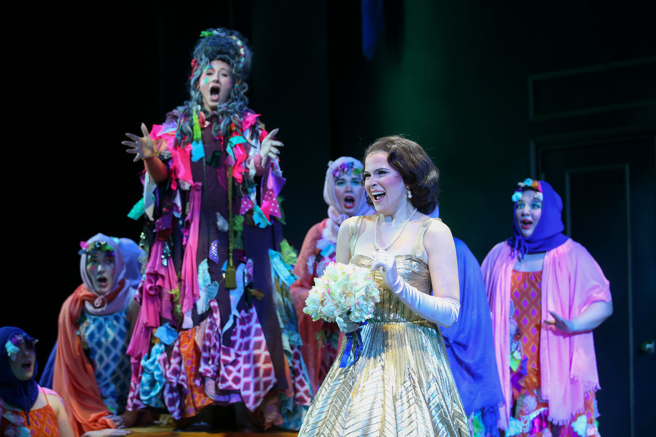 Cendrillon and the fairy godmother sing with ensemble members surrounding them.
