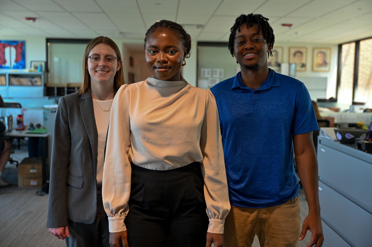 Adesewa Adeyefa is shown standing front and center with Caroline Waller and Kofi Agyepong on either side of her in OIP's office