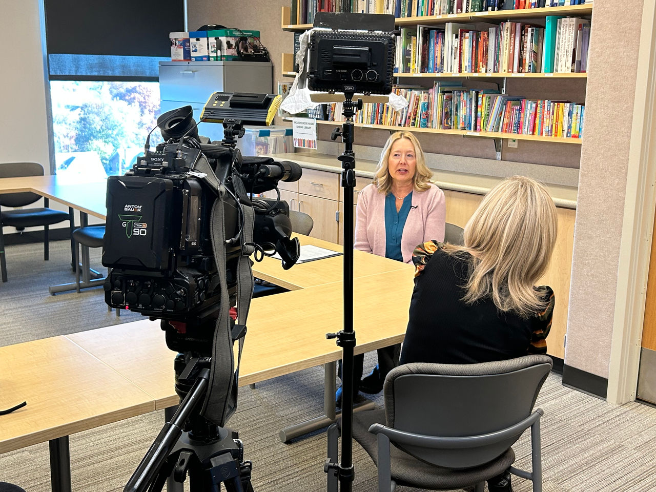 Reporter Liz Bonis interviewing speech-language pathologist Katrina Purcell 