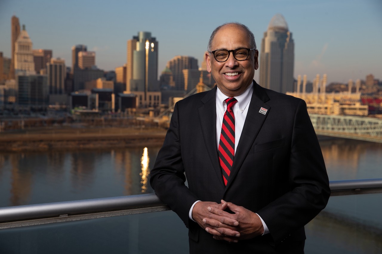 Dr. Neville Pinto in front of Cincinnati riverfront skyline