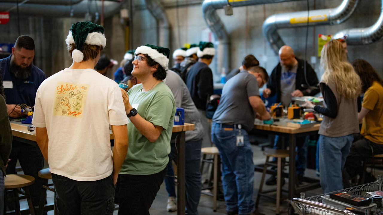 Students, staff and volunteers work inside the UC Ground Floor Makerspace. 