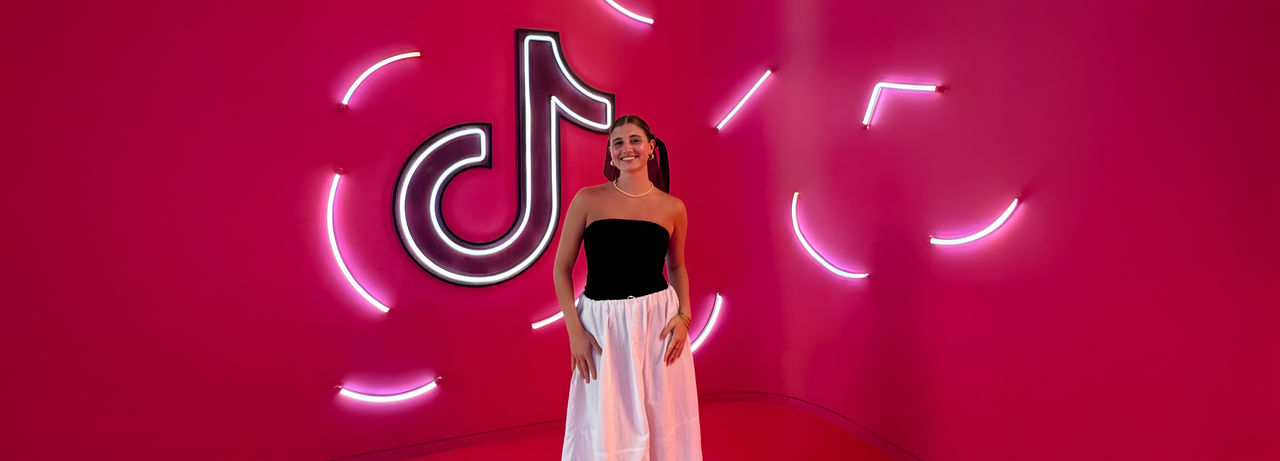 Delfina Lassalle standing in front of a TikTok sign