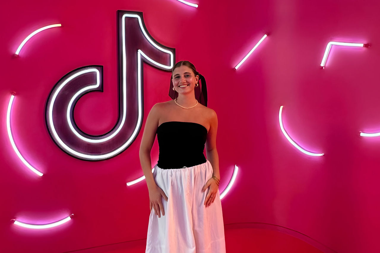 Delfina Lassalle standing in front of a TikTok sign