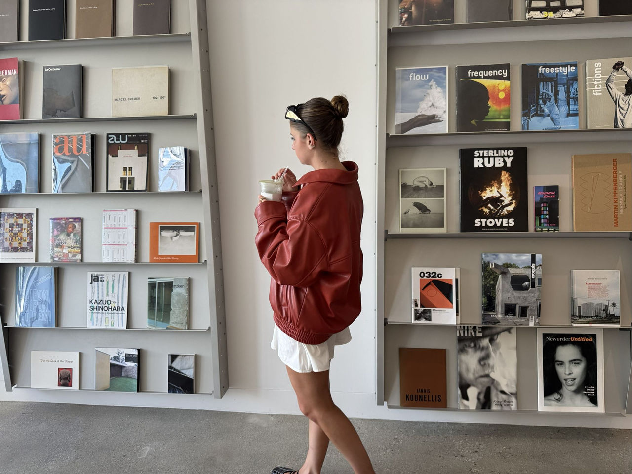 Delfina Lassalle strolling through TikTok headquarters with bookshelf in the background.