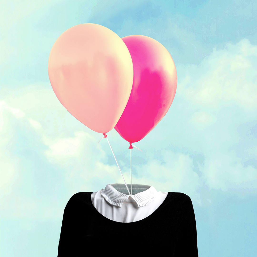 surreal minimalist man with big white balloon suspended over his head