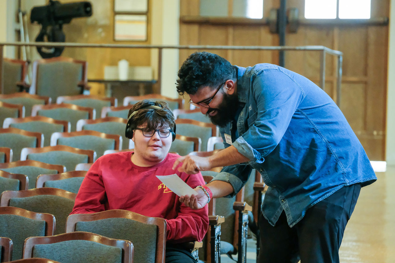 Zack Carreon from WVXU talks to a student at the Oyler School.