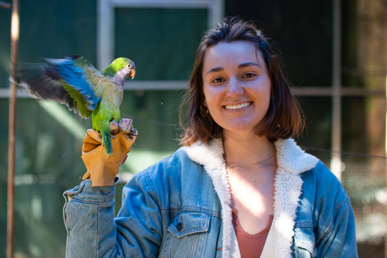 Claire O'Connell holds a parakeet.