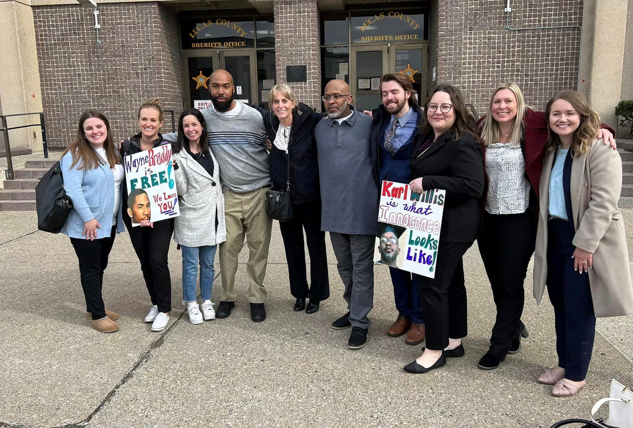 Image shows Karl Willis outside an Ohio law enforcement facility standing amidst a dozen supporters with some holding signs