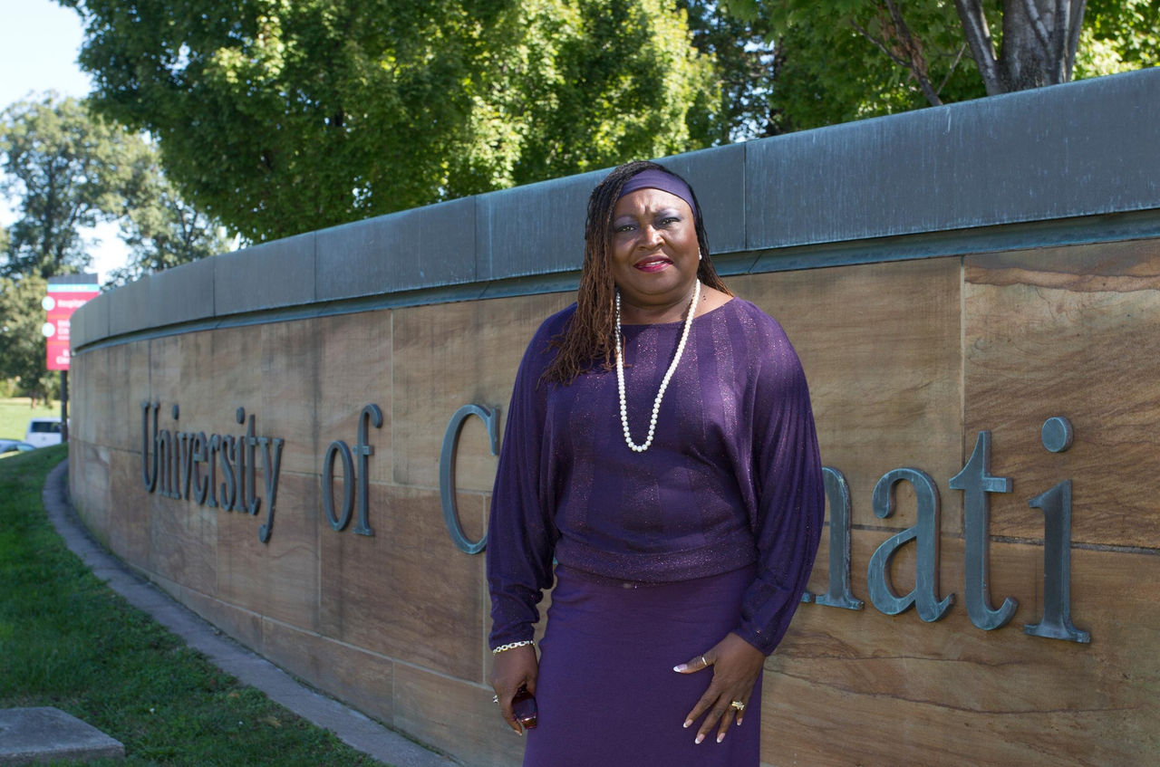 Karen Bankston standing in front of a University of Cincinnati sign