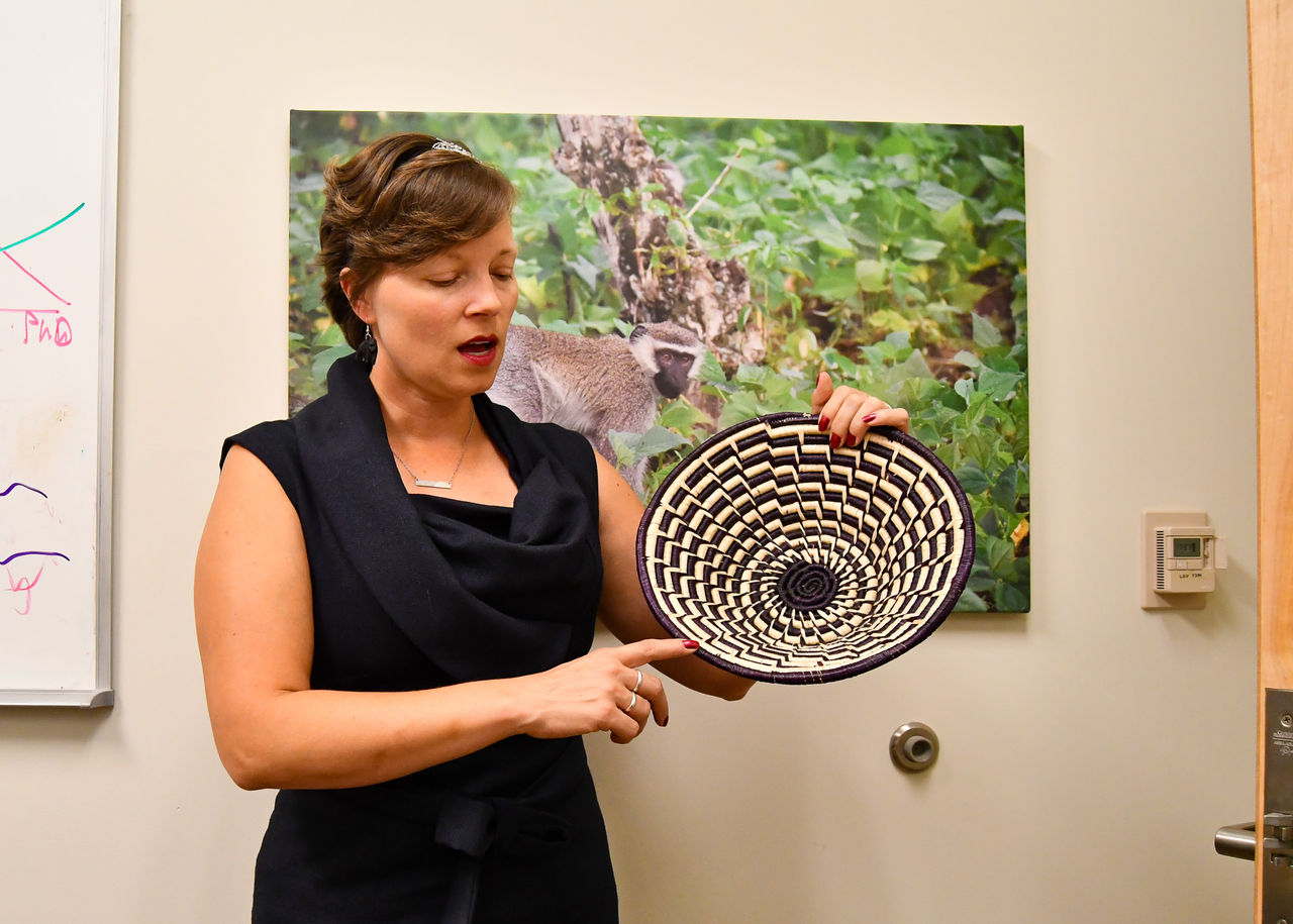 Kathleen Grogan holds up a photo of the Bwindi Impenetrable Forest.