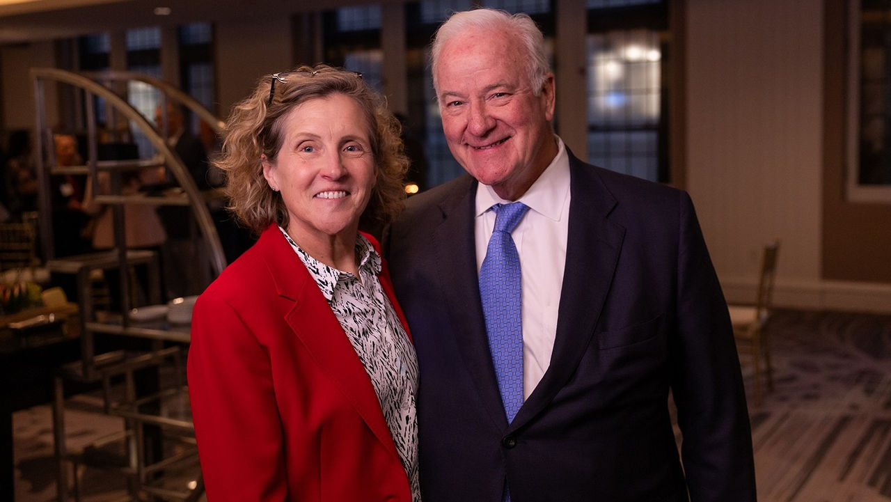 Lindner Dean Marianne Lewis, in a red jacket and white shirt, with Western & Southern head John Barrett, in a dark suit and tie.