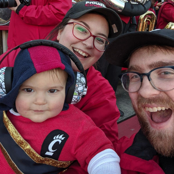 Natalie with her family at a UC Bearcats football game.