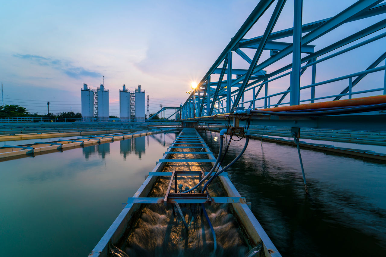 image of a wasterwater treatment in the background with close up of a water canal