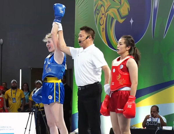 A referee declares Shea's victory.