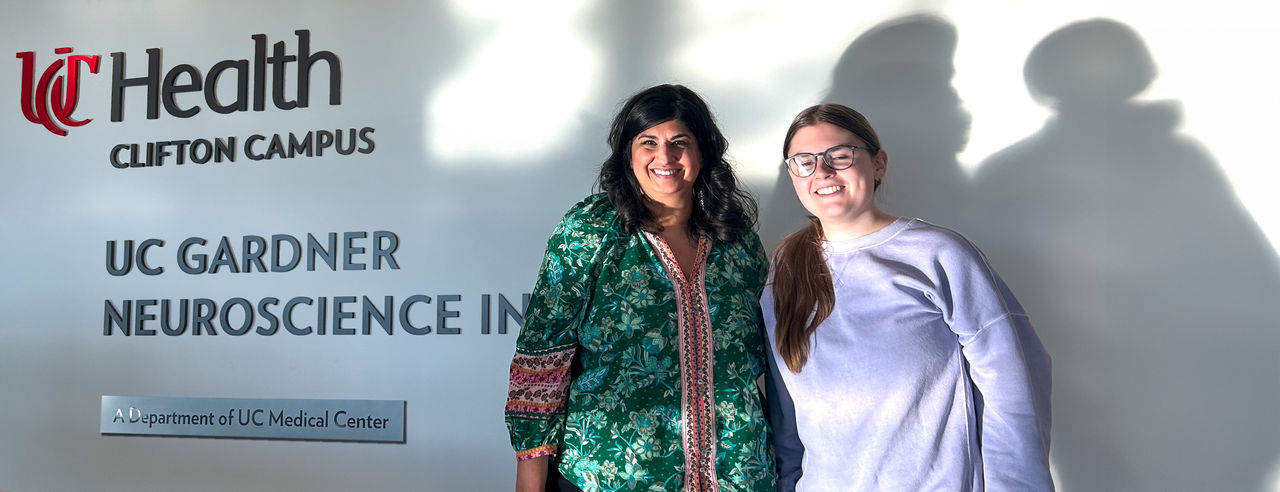  UC Clermont Professor Meera Rastogi (right) and Pre-Art Therapy student Malia Nerl at the UC Gardner Neuroscience Institute, where they use art to help patients handle the effects of movement disorders, like multiple sclerosis. 