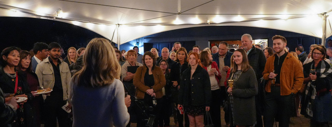 Group of people listening to speaker