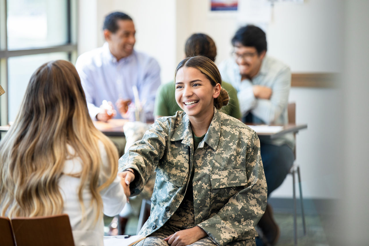A military-affiliated person receiving career advice. 