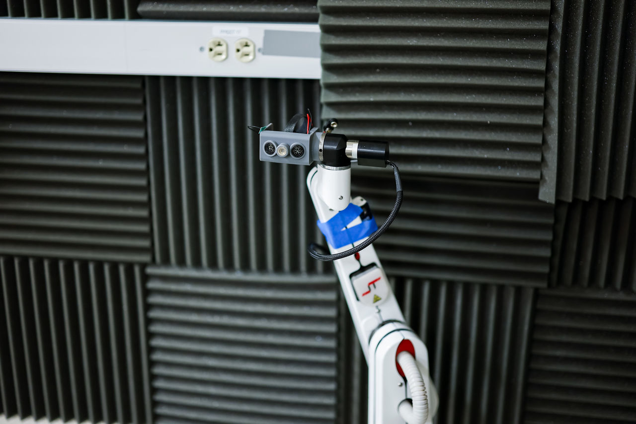 A robot is outfitted with stereo microphones to detec reflected echoes.