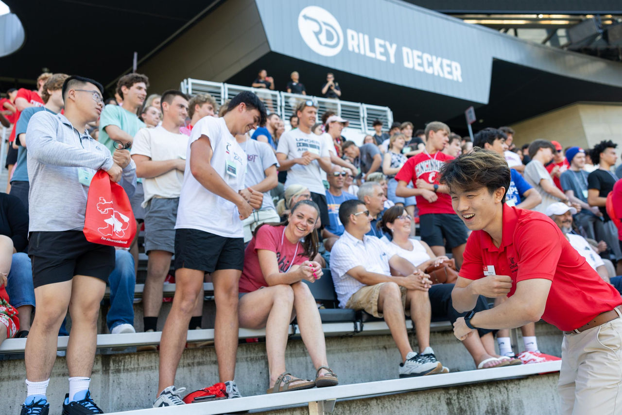 seveal studens shown performing the school spirit song in nippert stadium