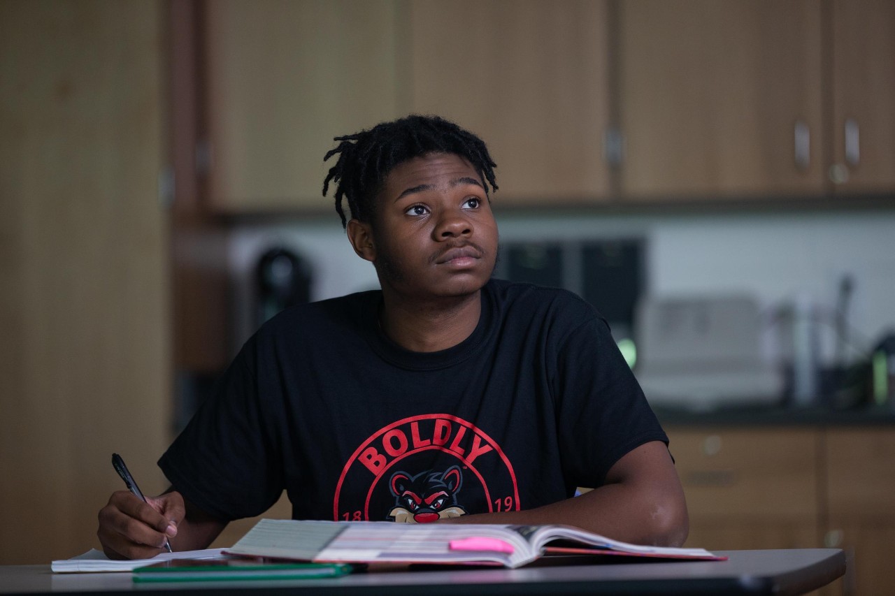 Jalen Tucker is a UC co-op student sitting in a desk in a classroom