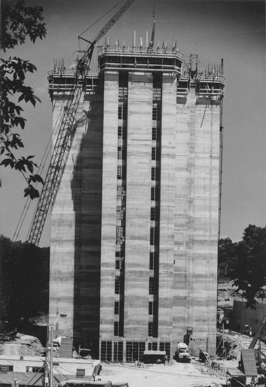 A 1969 photo shows construction cranes over the nearly complete tower.