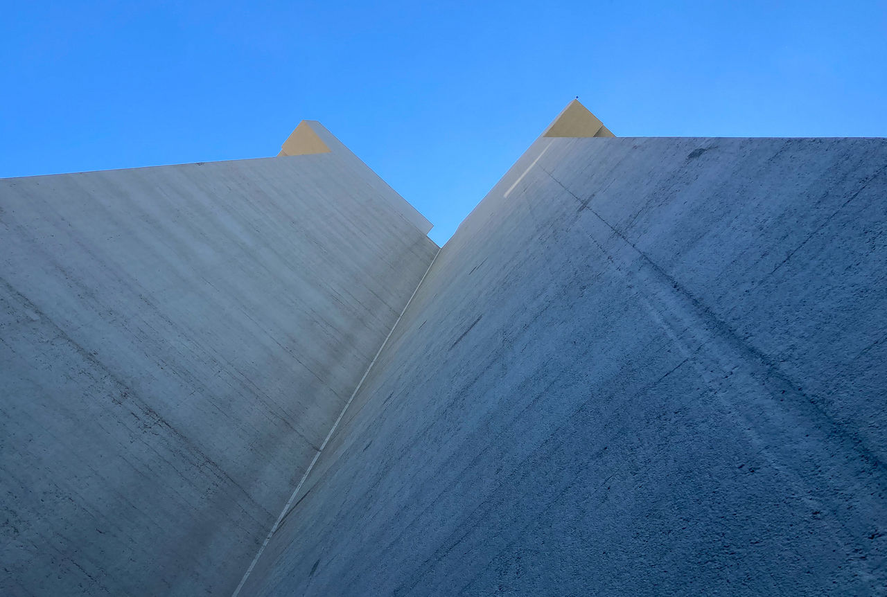 A view of Crosley Tower from its plaza looking straight up at the 90-degree concrete faces of one of its four wings.