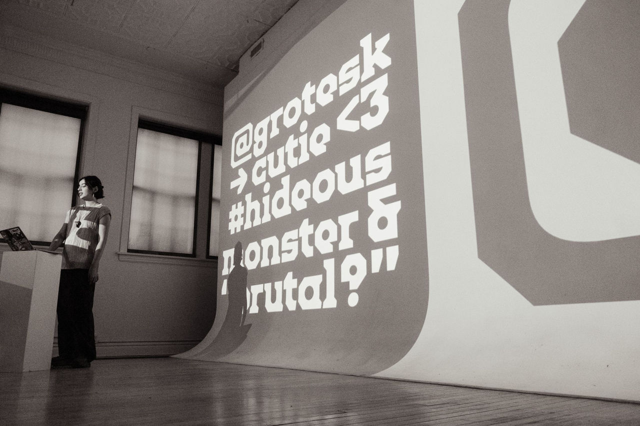 Juju Stroganovik standing in front of a podium with Crosby Tower font as a backdrop 