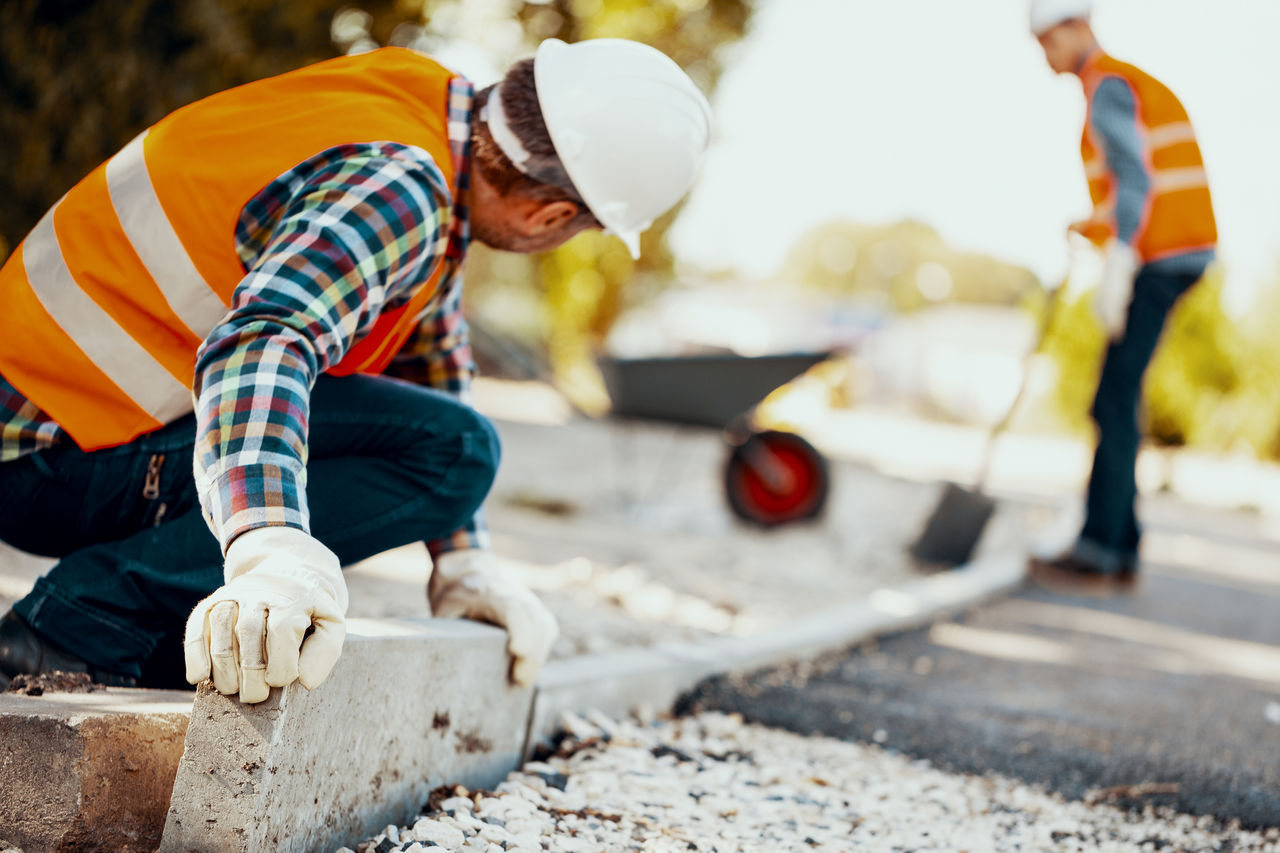 Road workers setting concrete