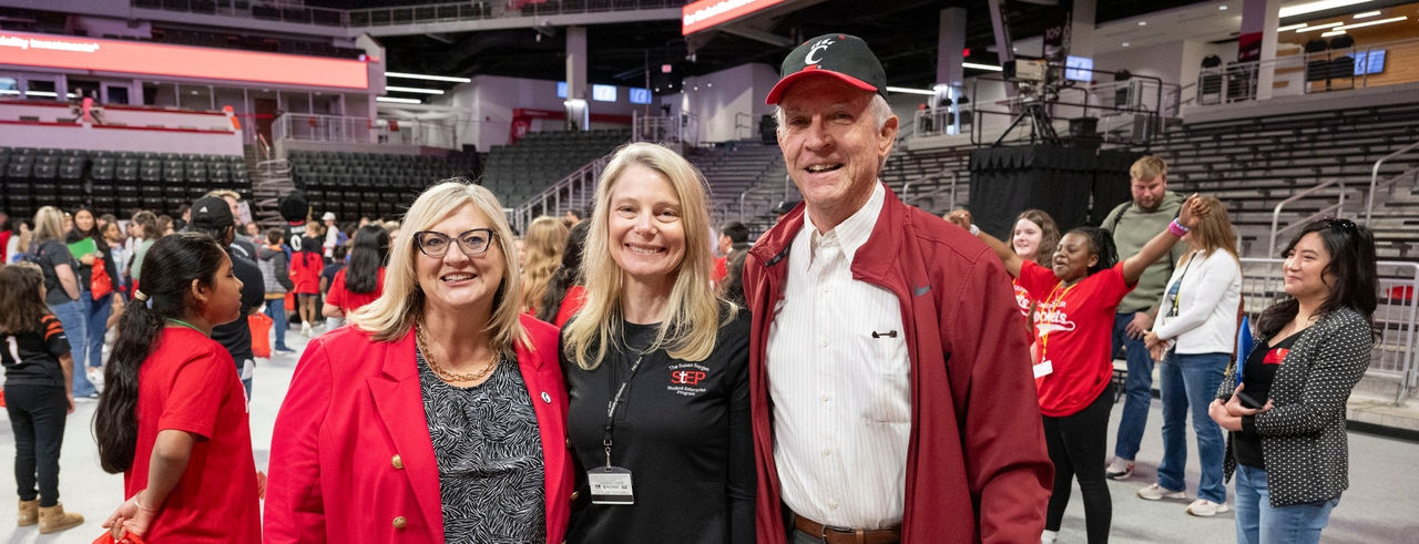 three smiling people