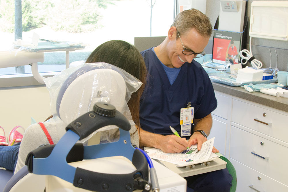 dentist working with a patient in chair